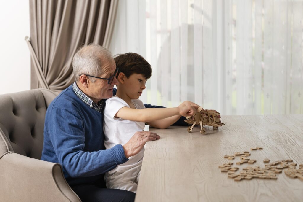 4 Wonderful Ways of Involving Grandparents in Toddler Finance Literacy: Building Intergenerational Money Wisdom 1 little boy playing with his grandfather Involving grandparents in toddler finance literacy,
Grandparent toddler financial education India,
Intergenerational money learning for toddlers,
Family financial wisdom across generations,
Grandparent teaching money to young children,